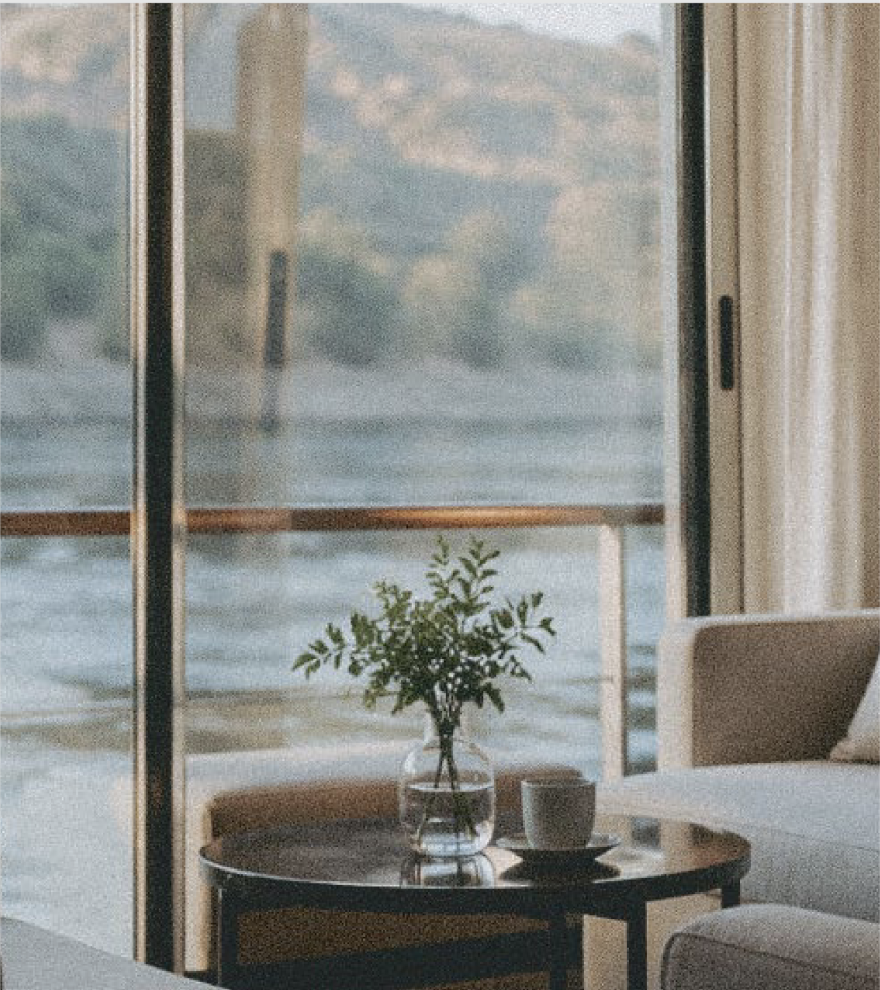 Lounge corner with armchair and table by a window over the river